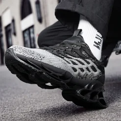 Men's Blue Athletic Sneakers with Unique Hollow Sole Design, Breathable Knit Upper, and Flame Detail – Lightweight Running Shoes with Orange Accents